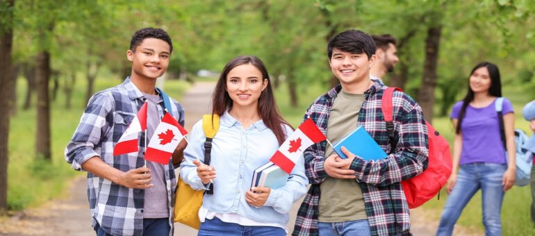 Group of students with Canadian flags outdoors